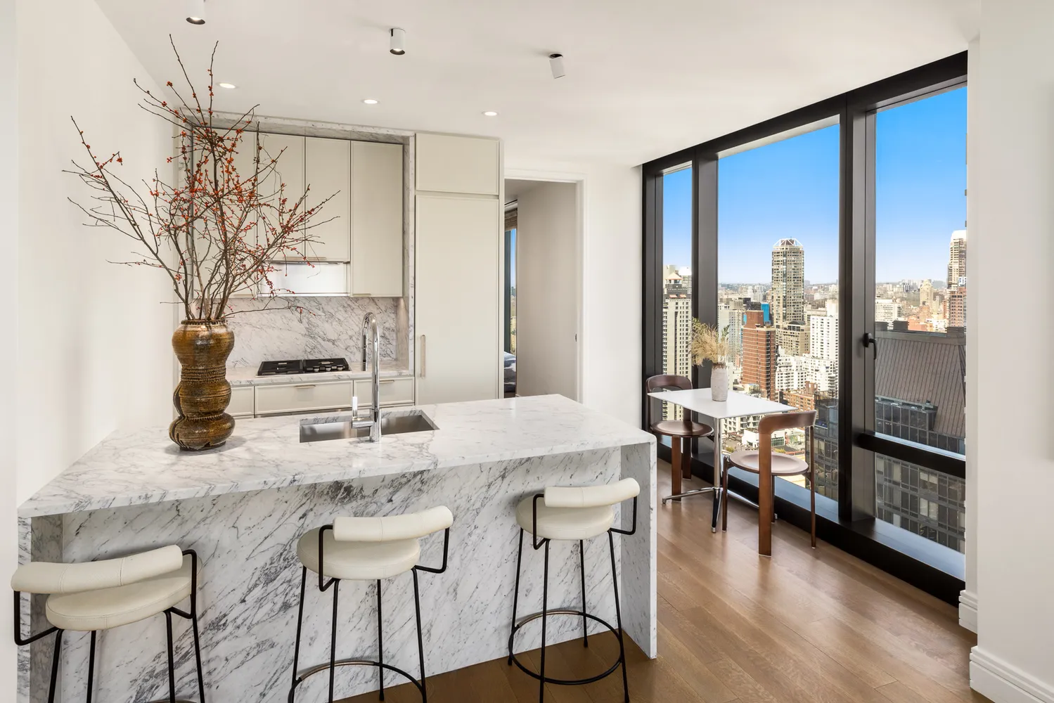 a kitchen with granite countertop a table chairs stove and wooden floor