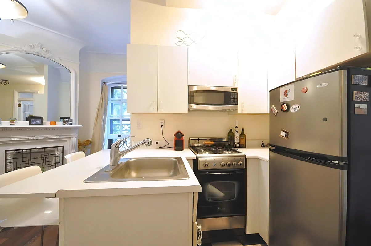 2109 Broadway, Unit 531 Manhattan, NY 10023 - Photo 4 of 8 a kitchen with a sink a stove and refrigerator