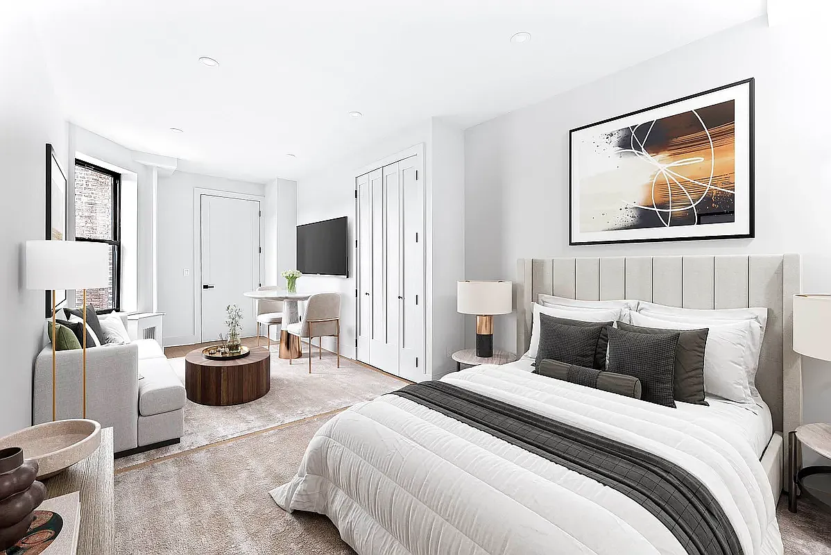 16 Barrow Street, Unit 4B Manhattan, NY 10014 - Photo 2 of 7 a bedroom with a bed and a couch