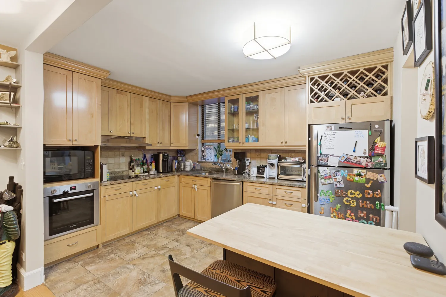 a kitchen with a refrigerator and a stove top oven