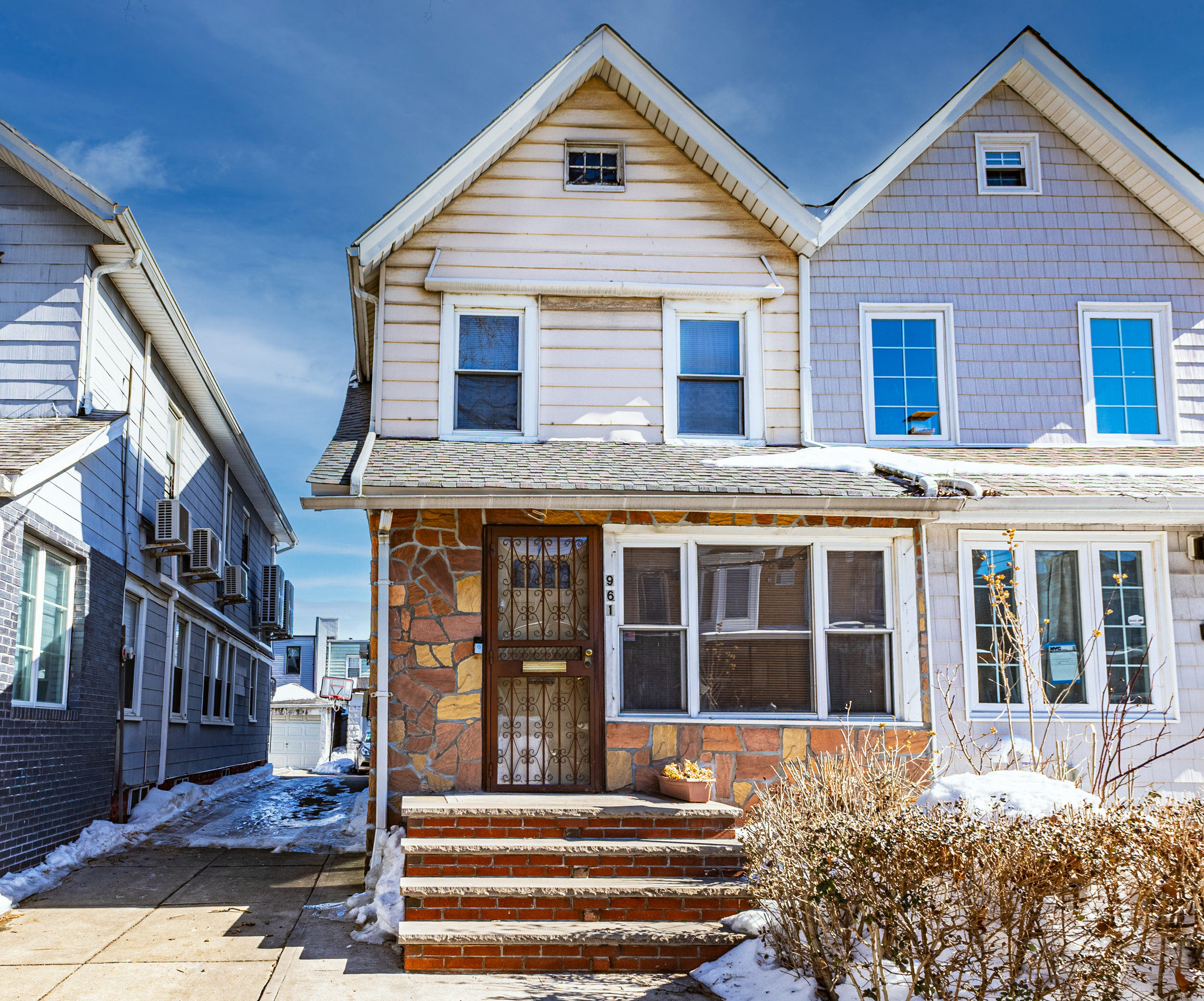 961 East 32nd Street Brooklyn, NY 11210 - Photo 2 of 24 a front view of a house with a garden