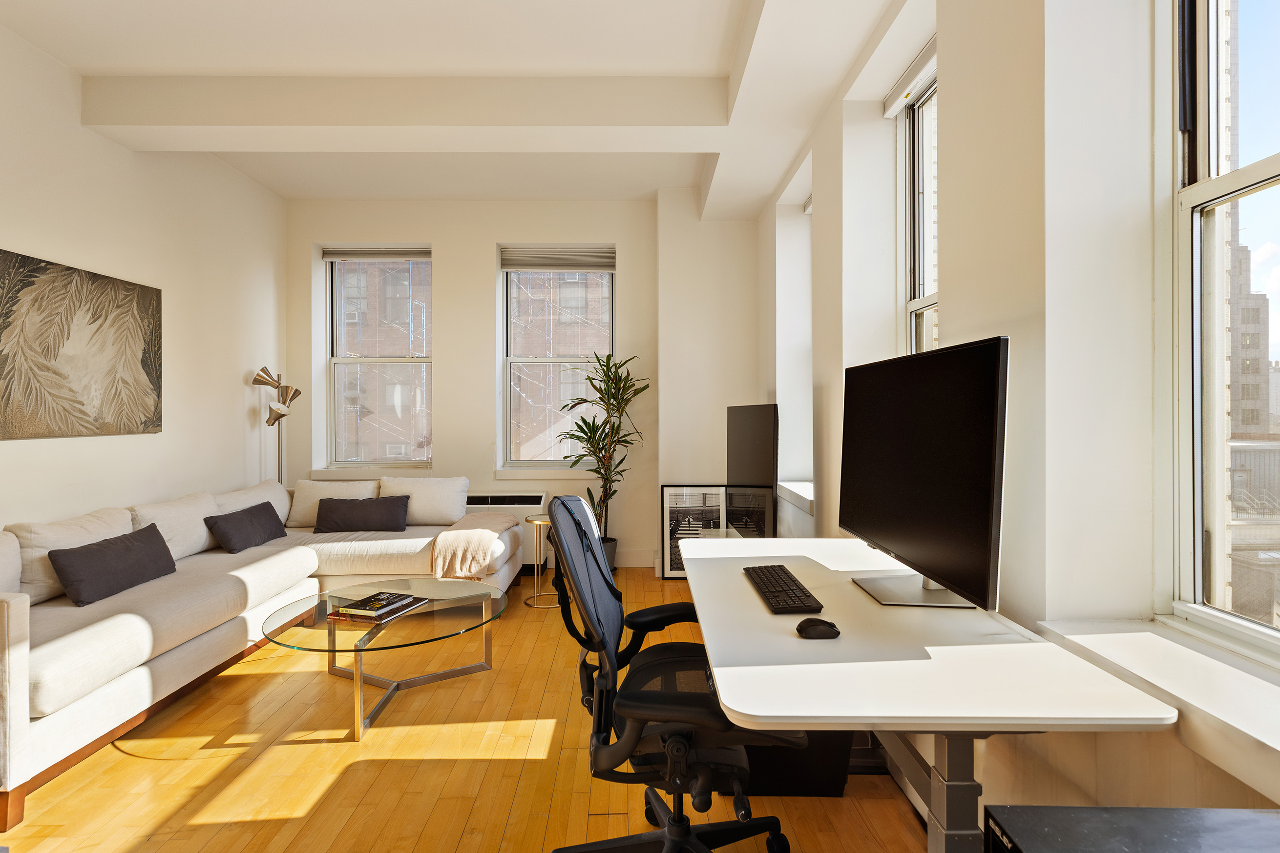 80 Chambers Street, Unit 11A Manhattan, NY 10007 - Photo 8 of 24 a work room with furniture and a flat screen tv