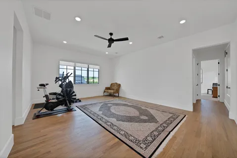 a living room with hard wood flooring and furniture