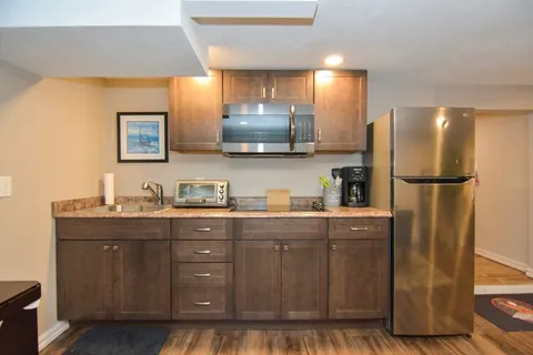 a kitchen with stainless steel appliances granite countertop a refrigerator and a sink