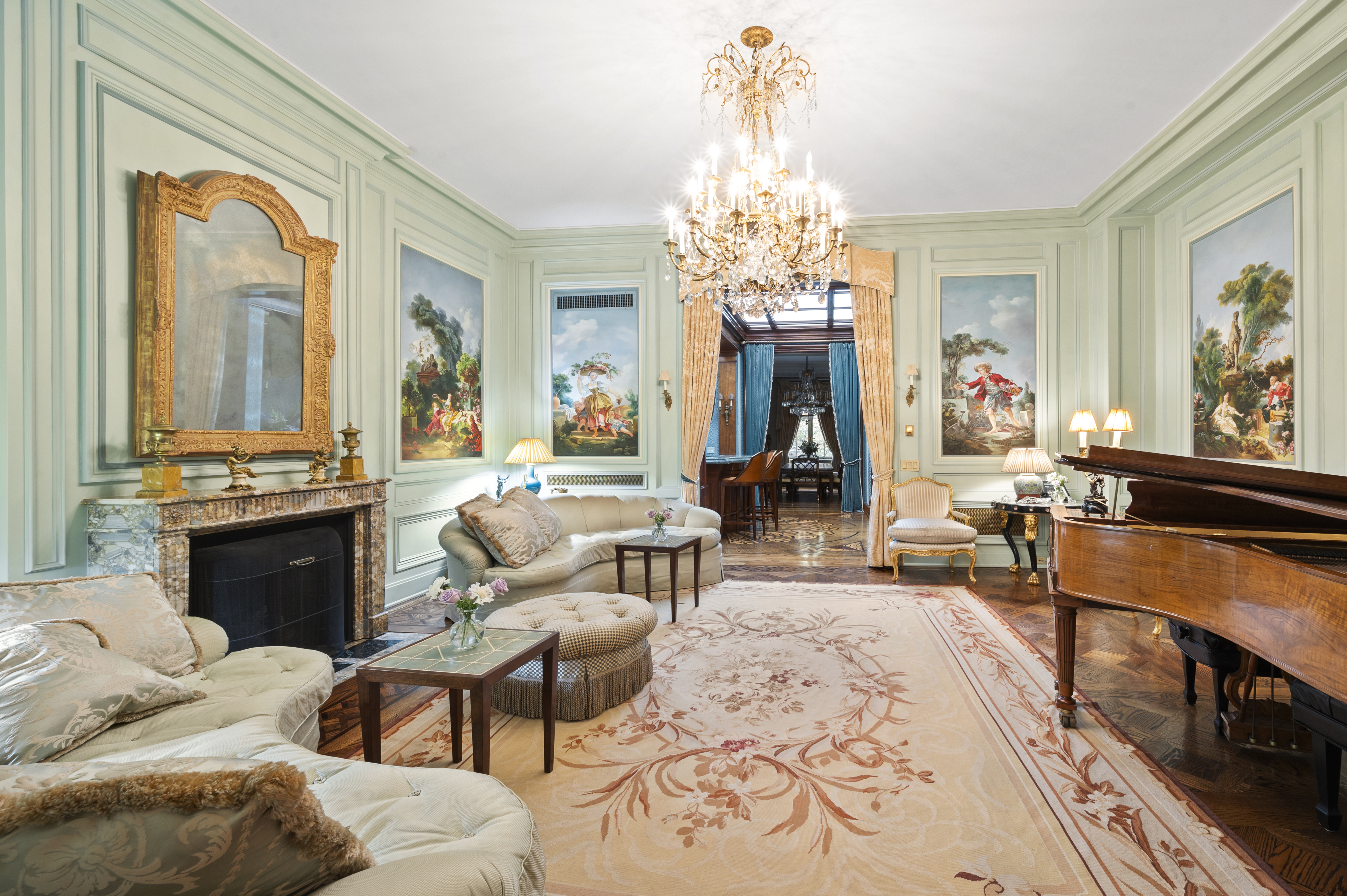 163 East 64th Street Manhattan, NY 10065 - Photo 19 of 34 a living room with furniture a chandelier and a flat screen tv