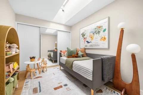 a bedroom with bed and wooden floor