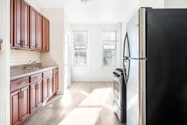 a kitchen with a refrigerator and a sink