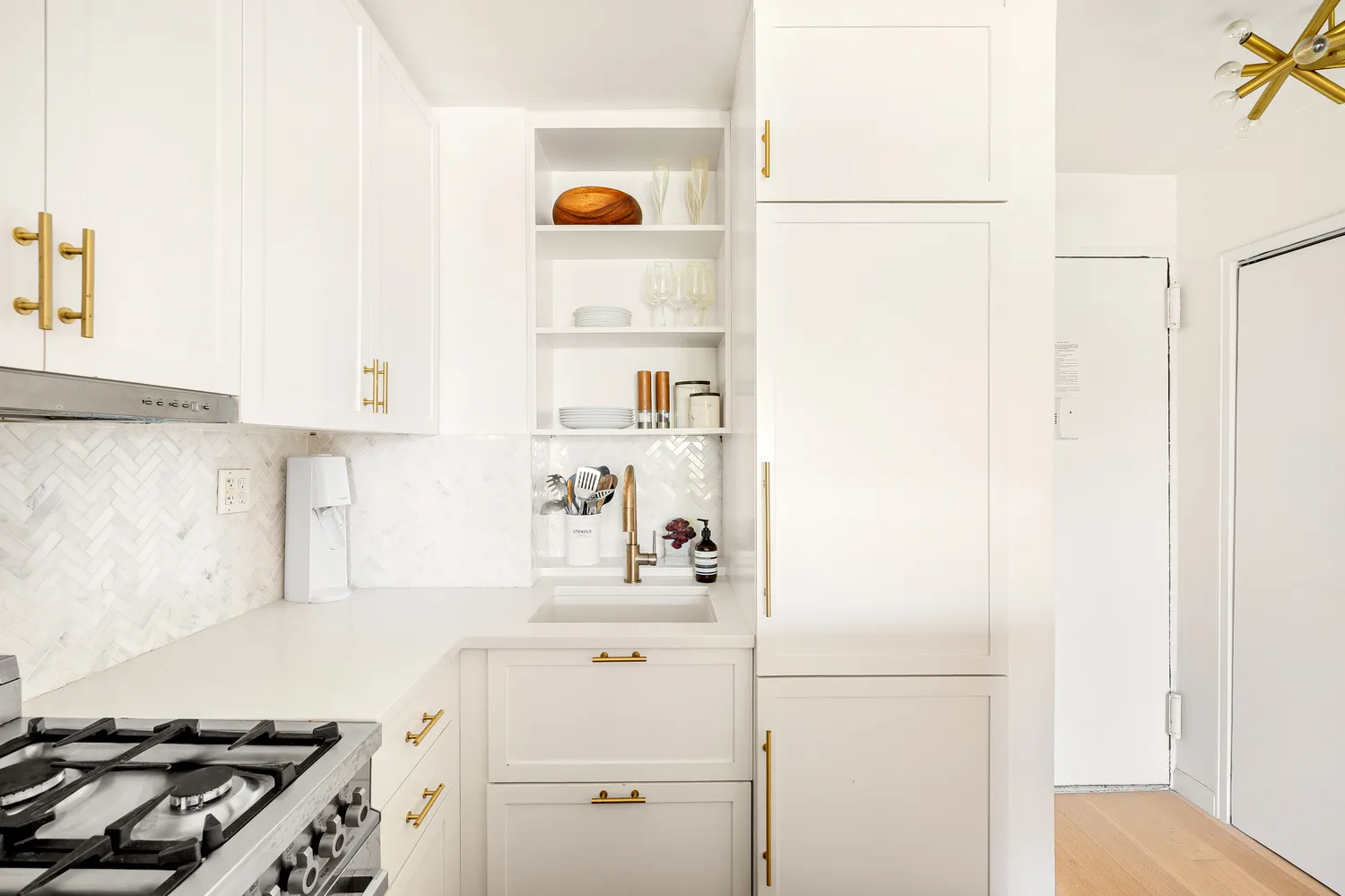 a kitchen with a refrigerator and a stove
