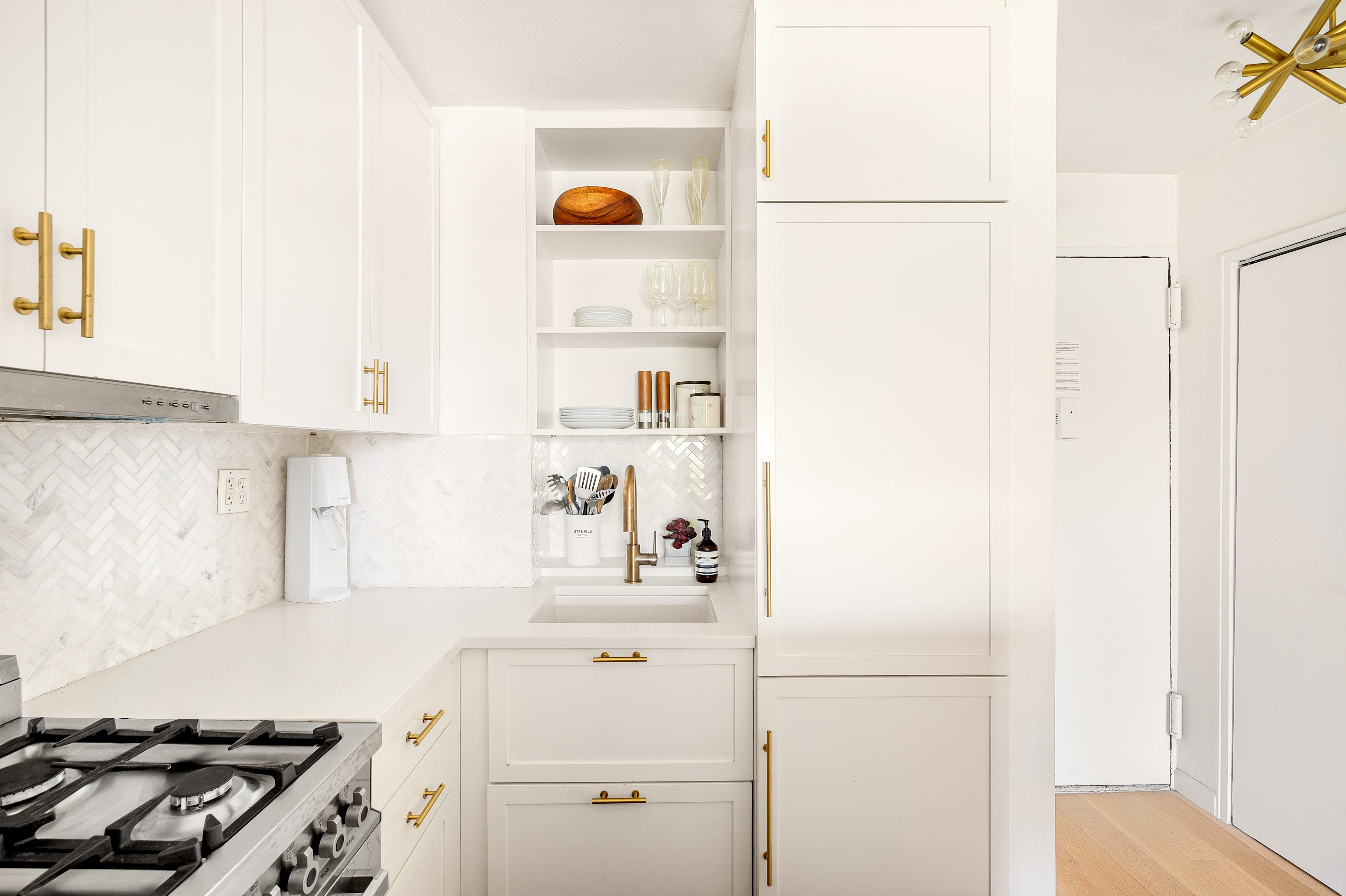 165 Christopher Street, Unit 5DD Manhattan, NY 10014 - Photo 9 of 15 a kitchen with a refrigerator and a stove