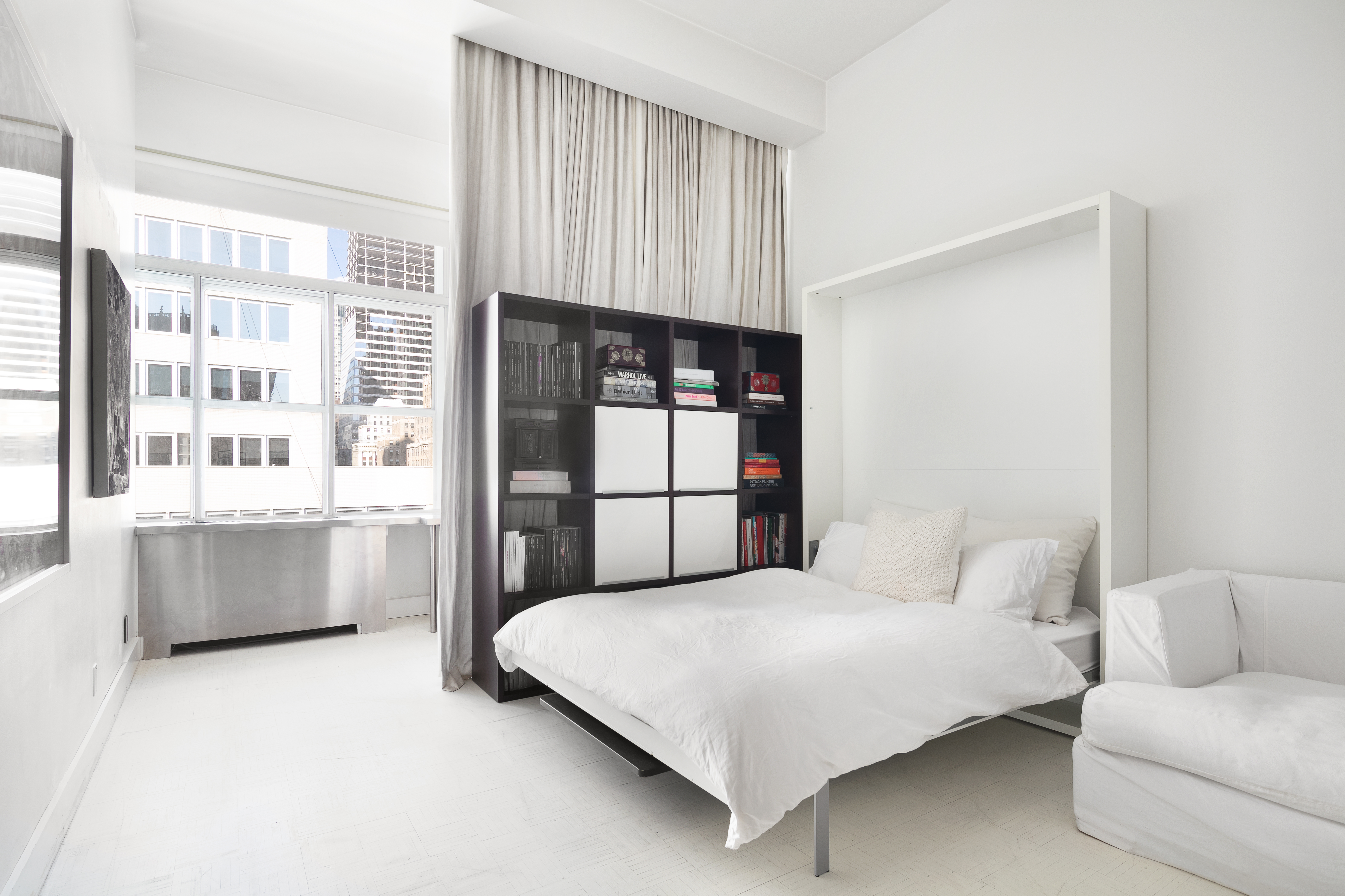 244 Madison Avenue, Unit PHE Manhattan, NY 10016 - Photo 4 of 20 a bedroom with a large bed and a large window