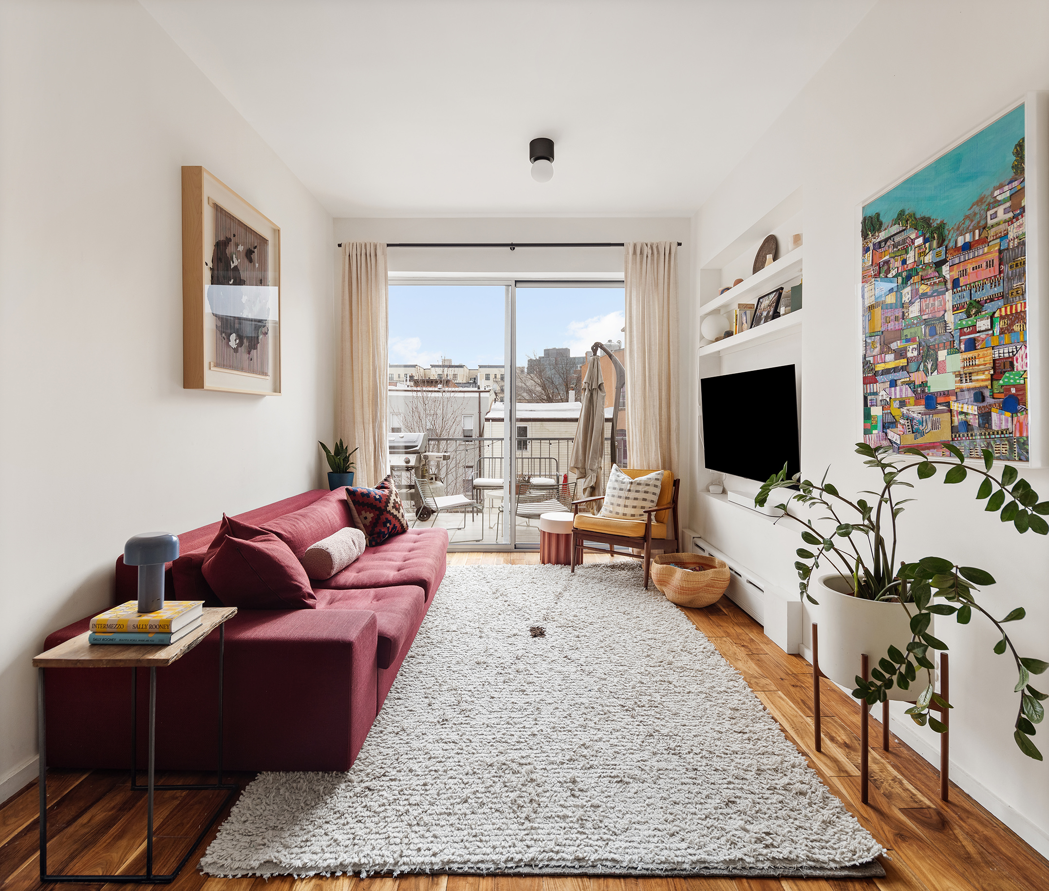 58 A Madison Street, Unit 2 Brooklyn, NY 11238 - Photo 2 of 12 a living room with furniture and a flat screen tv