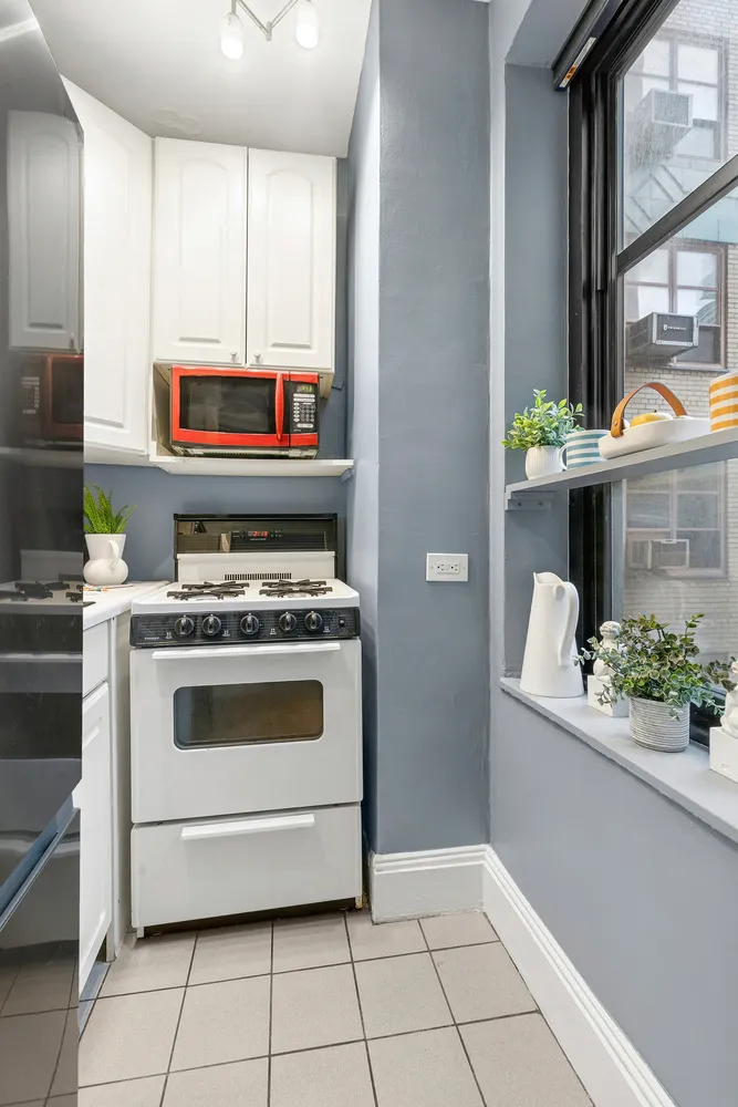 a kitchen with stainless steel appliances a stove a microwave and cabinets