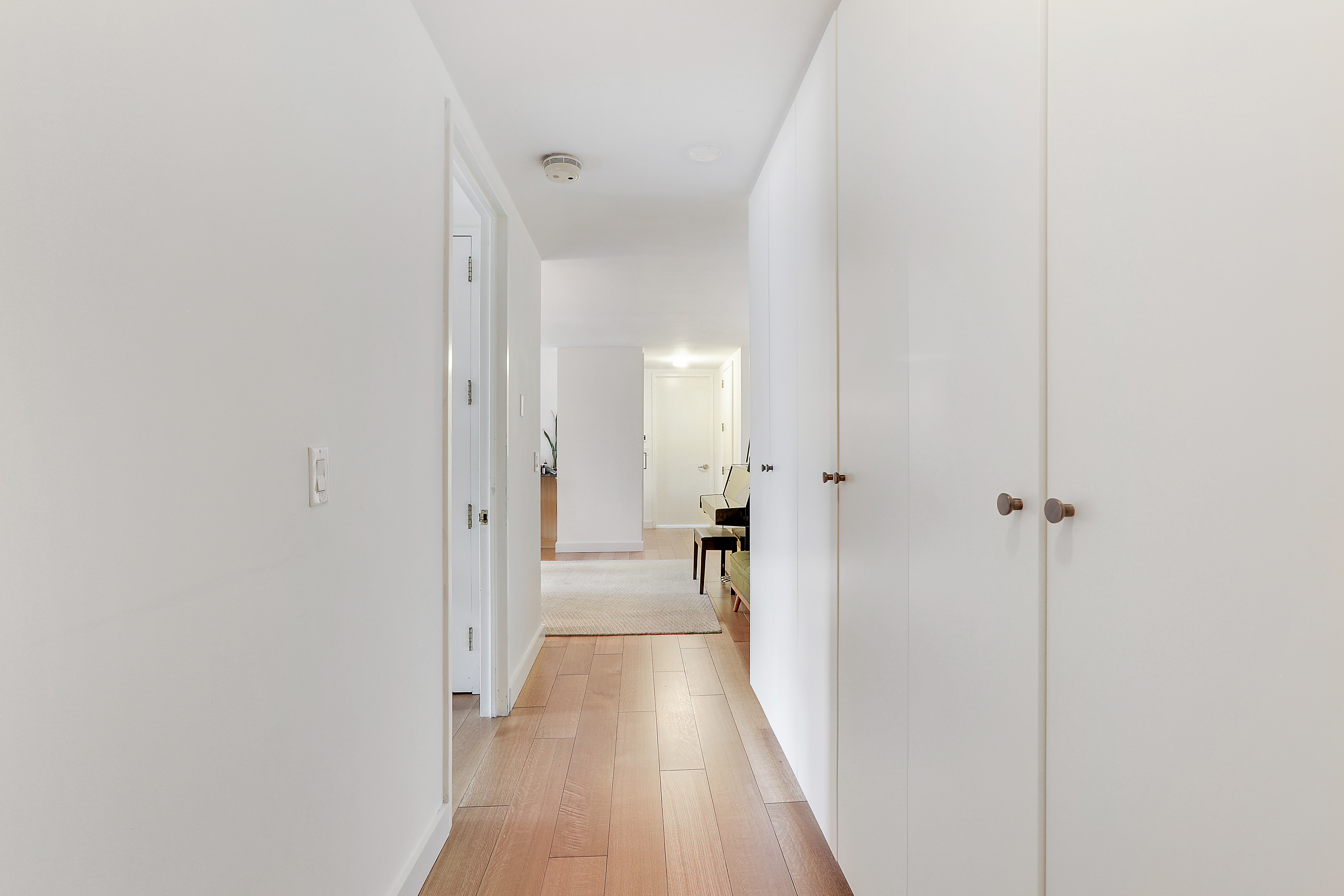 1965 Broadway, Unit 14H Manhattan, NY 10023 - Photo 5 of 10 a view of a hallway with wooden floor