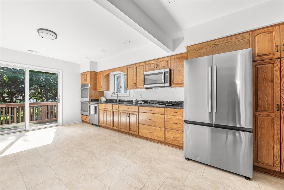 1902 Rookwood Road Silver Spring, MD 20910 - Photo 18 of 36 a kitchen with stainless steel appliances granite countertop a refrigerator sink and cabinets