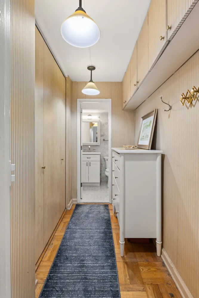 a view of a hallway with wooden floor windows and entryway