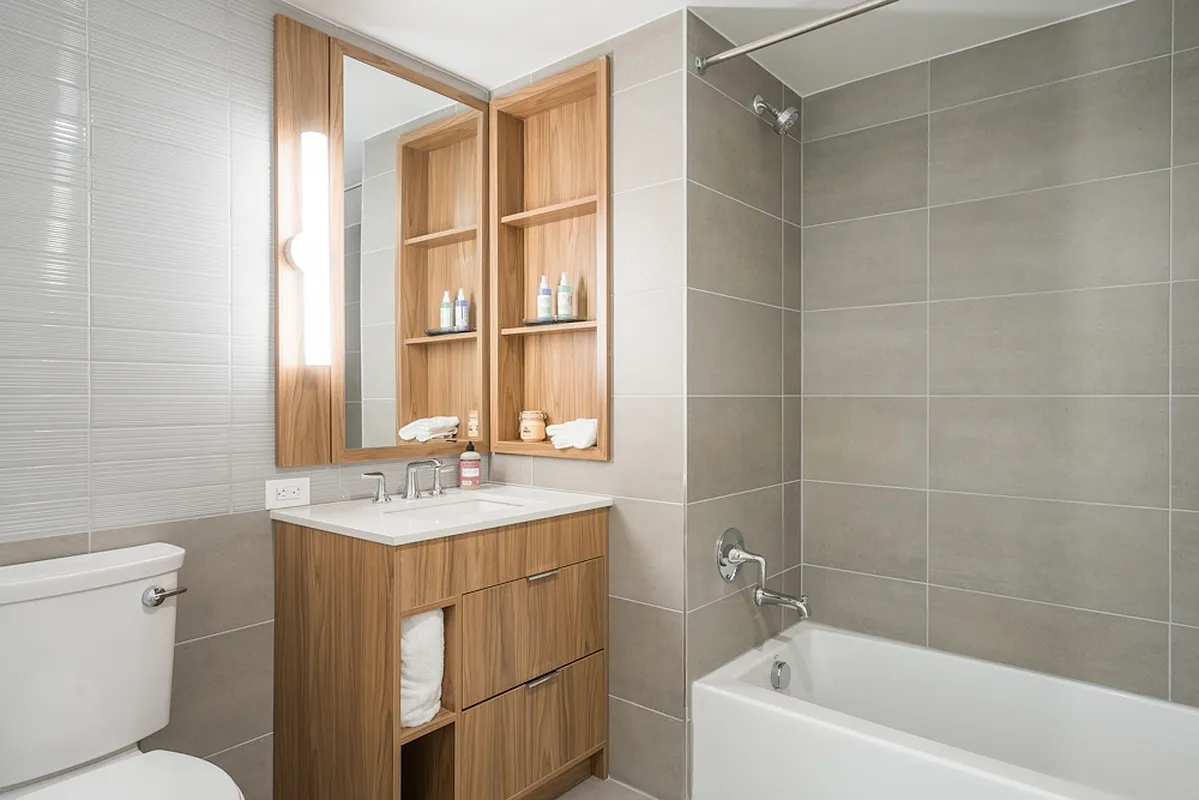 975 Nostrand Avenue, Unit 241 Brooklyn, NY 11225 - Photo 9 of 18 a bathroom with a sink toilet vanity and tub