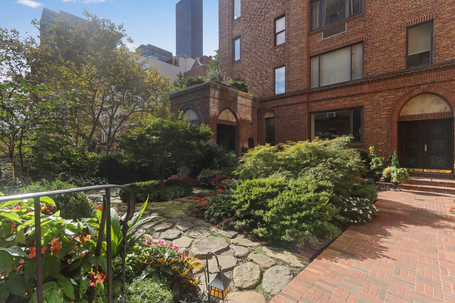 455 East 51st Street, Unit 6B Manhattan, NY 10022 - Photo 16 of 17 a house with a trees in front of it