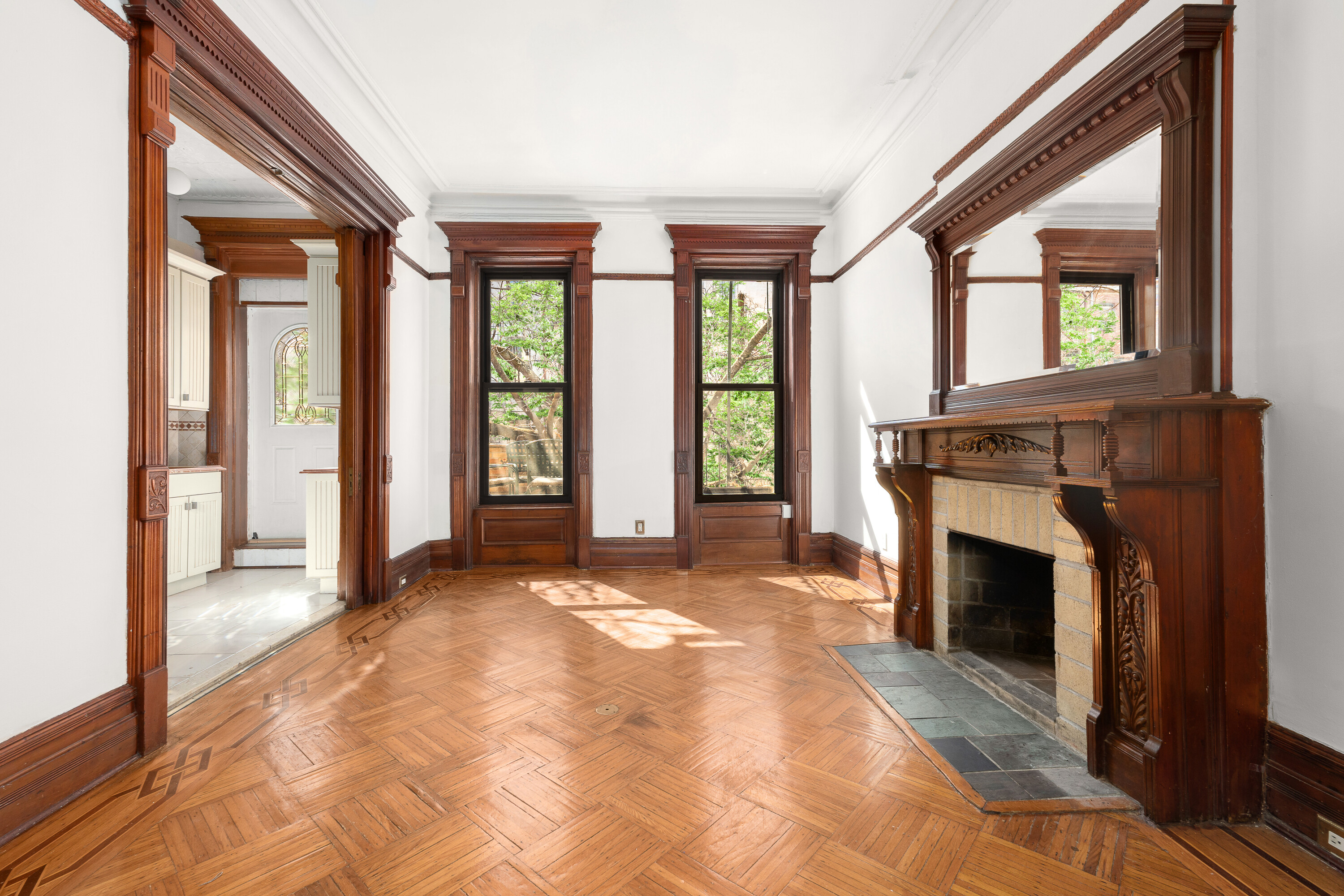 a view of an empty room with window and fire place