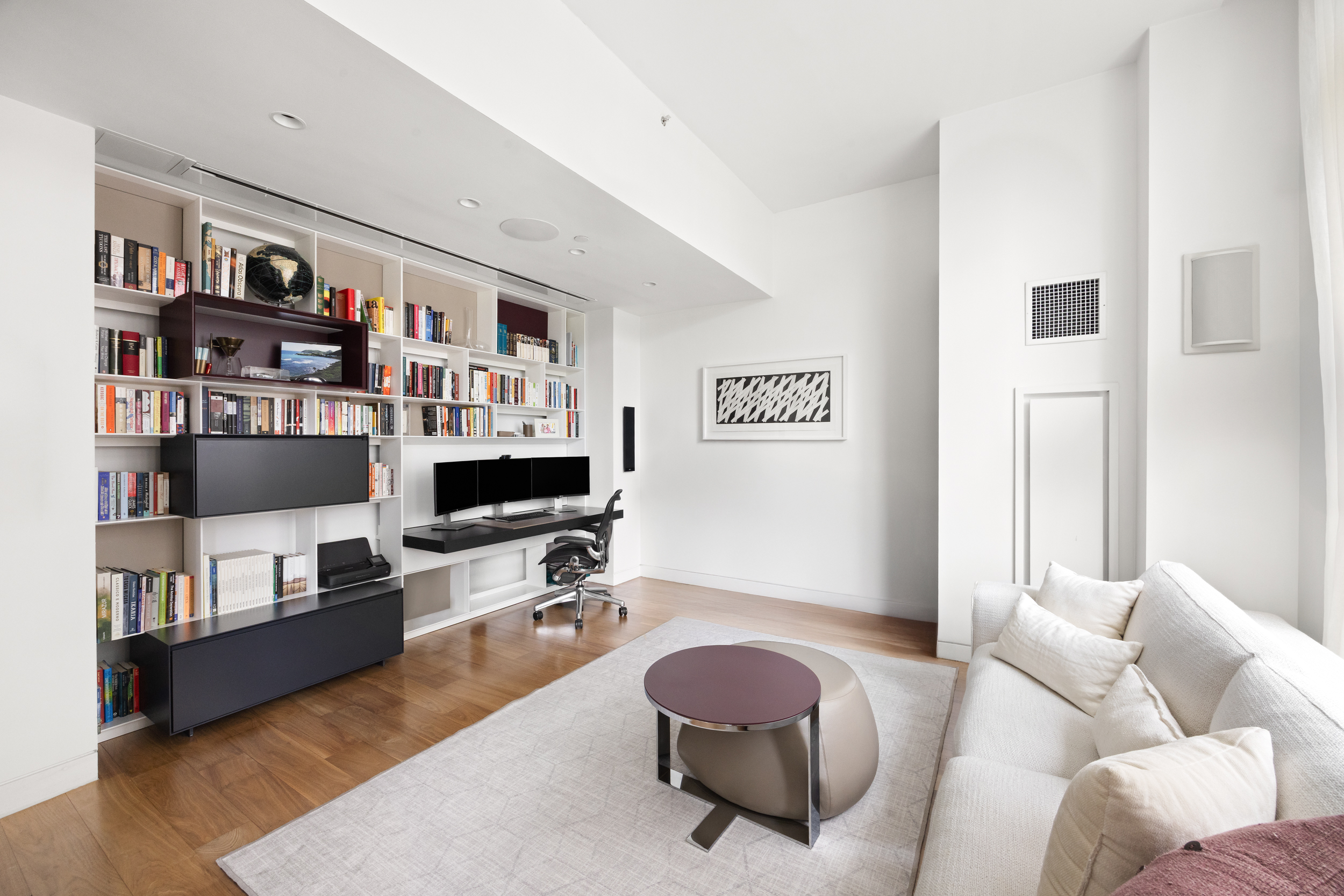 200 Chambers Street, Unit 7AI Manhattan, NY 10007 - Photo 14 of 28 a living room with furniture and a bookshelf