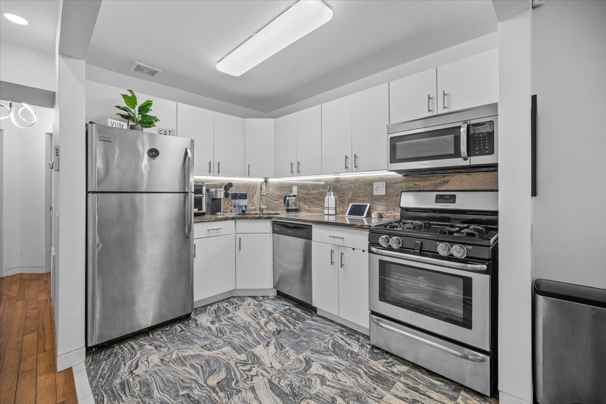 1477 Prospect Place, Unit 2 Brooklyn, NY 11213 - Photo 5 of 14 a kitchen with a refrigerator stove and microwave