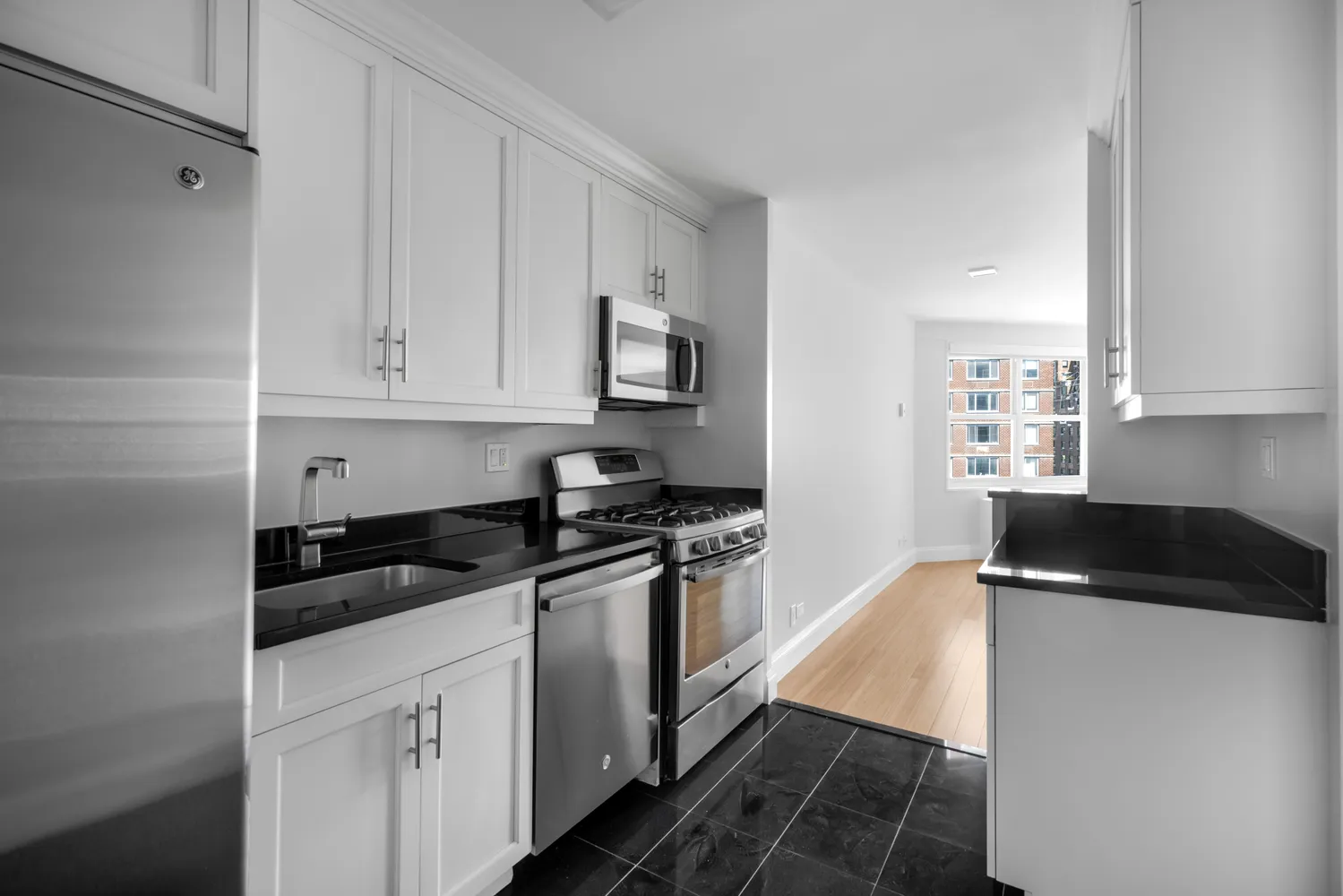 a kitchen with granite countertop a sink and cabinets