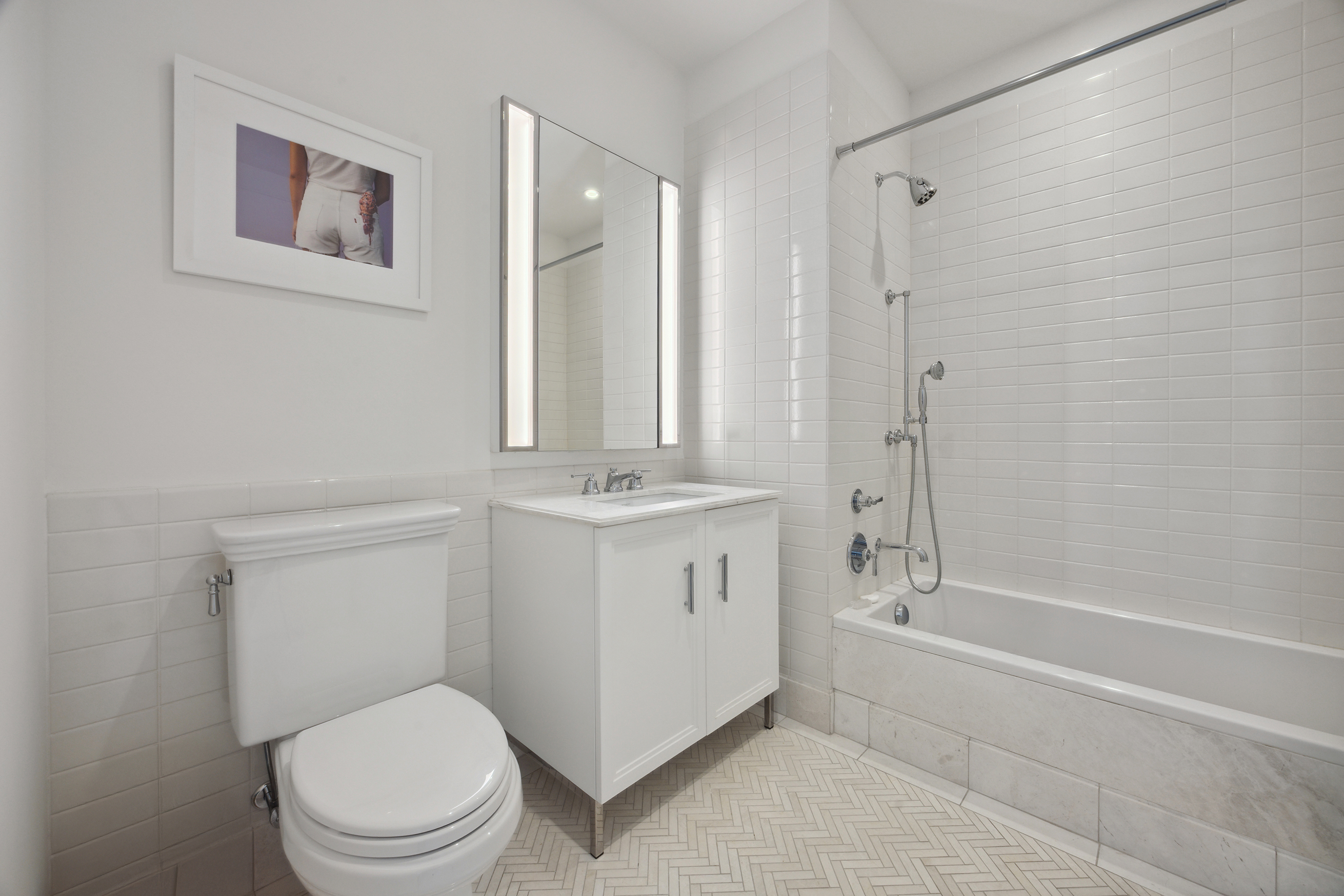 100 Barclay Street, Unit 15B Manhattan, NY 10007 - Photo 13 of 16 a bathroom with a toilet a sink and mirror