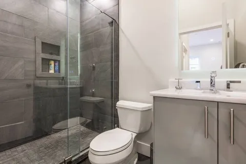 a bathroom with a toilet a sink and shower