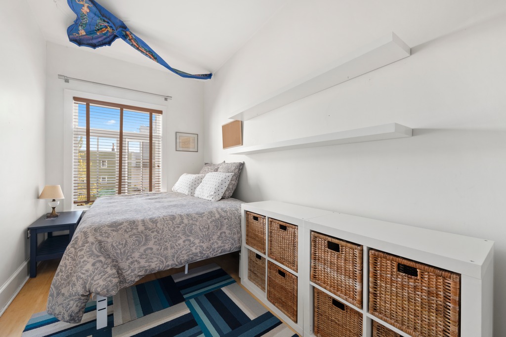 82 Visitation Place, Unit 2 Brooklyn, NY 11231 - Photo 5 of 12 a bedroom with a bed and a large window with wooden floor