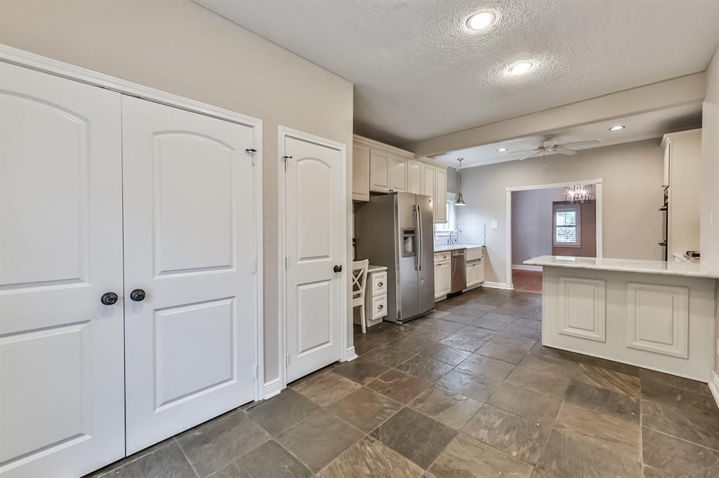 1120 Winston Street Houston, TX 77009 - Photo 16 of 29 a view of a kitchen with refrigerator and cabinets