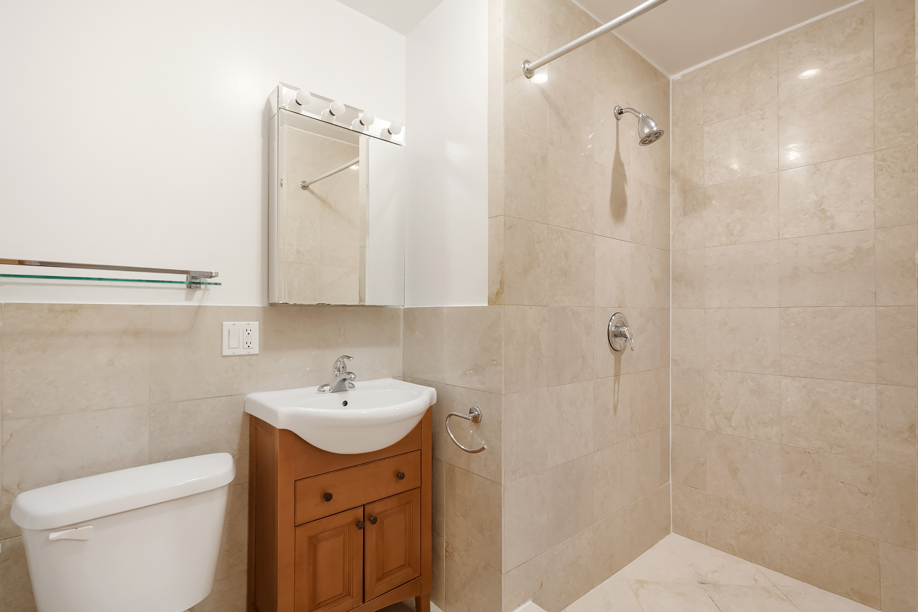 205 West 10th Street, Unit GARDEN Manhattan, NY 10014 - Photo 7 of 8 a bathroom with a sink a toilet and a mirror