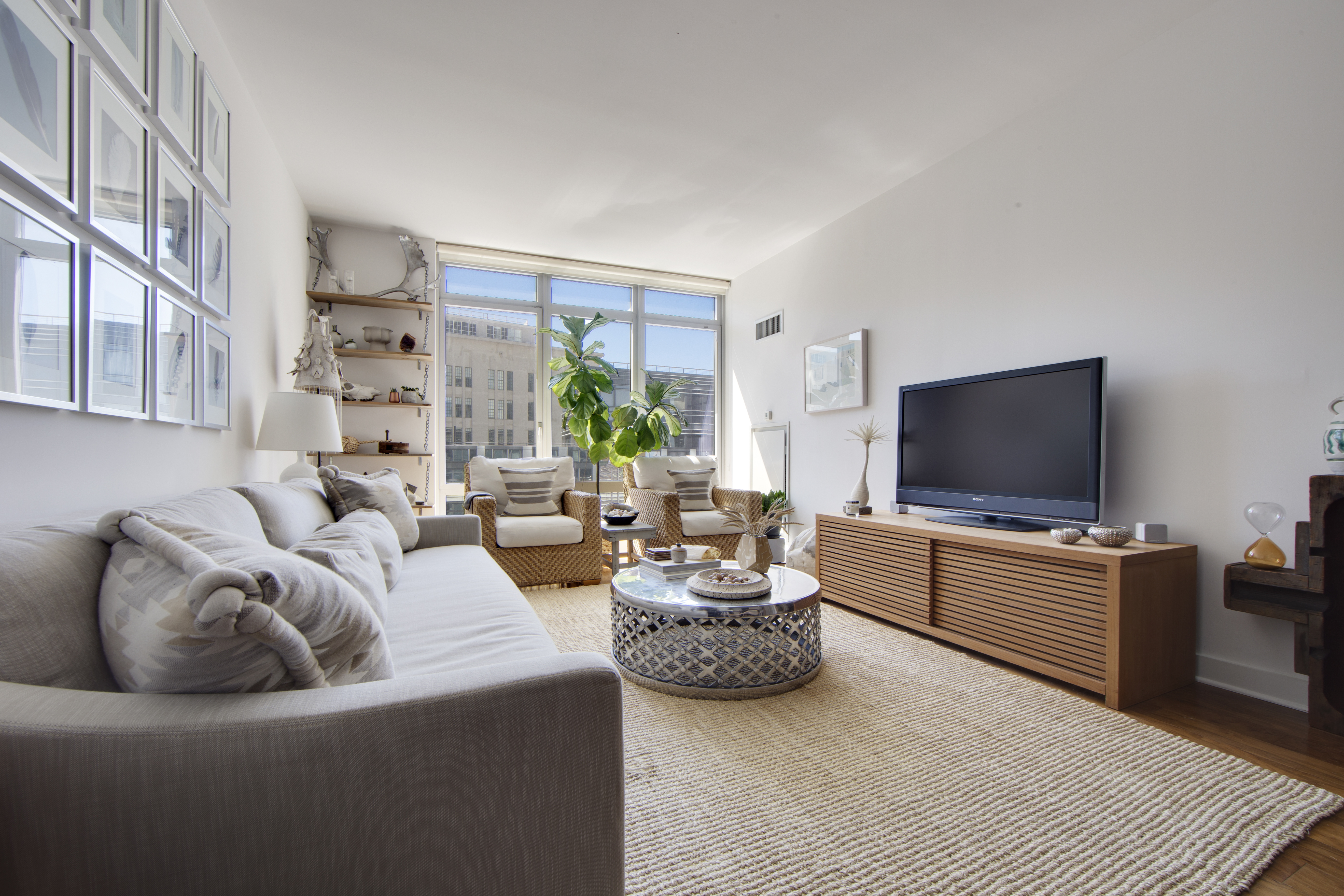 2 Northside Piers, Unit 4B Brooklyn, NY 11249 - Photo 3 of 18 a living room with furniture and a flat screen tv