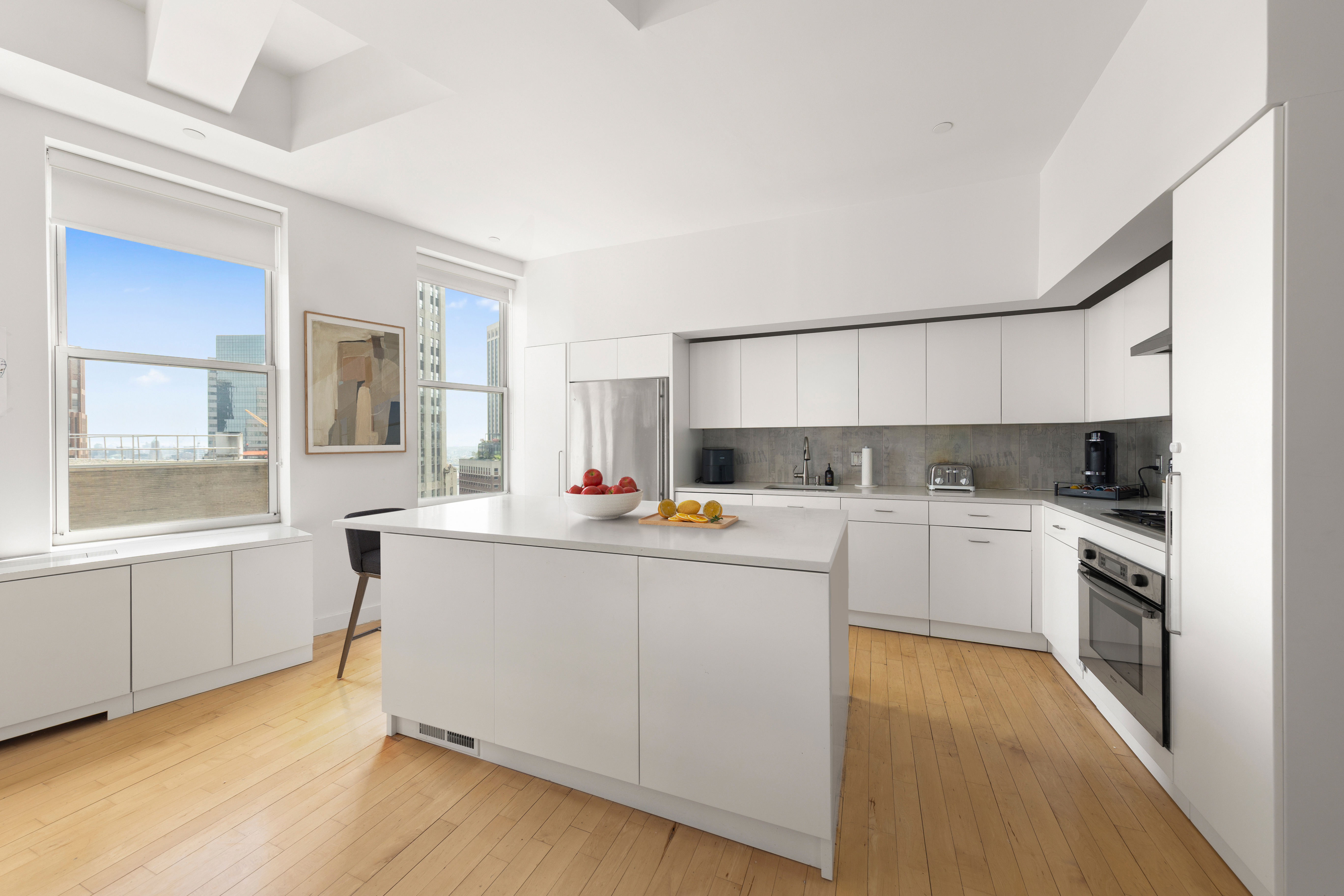 15 Broad Street, Unit 3100 Manhattan, NY 10005 - Photo 5 of 27 a kitchen with a sink cabinets and window