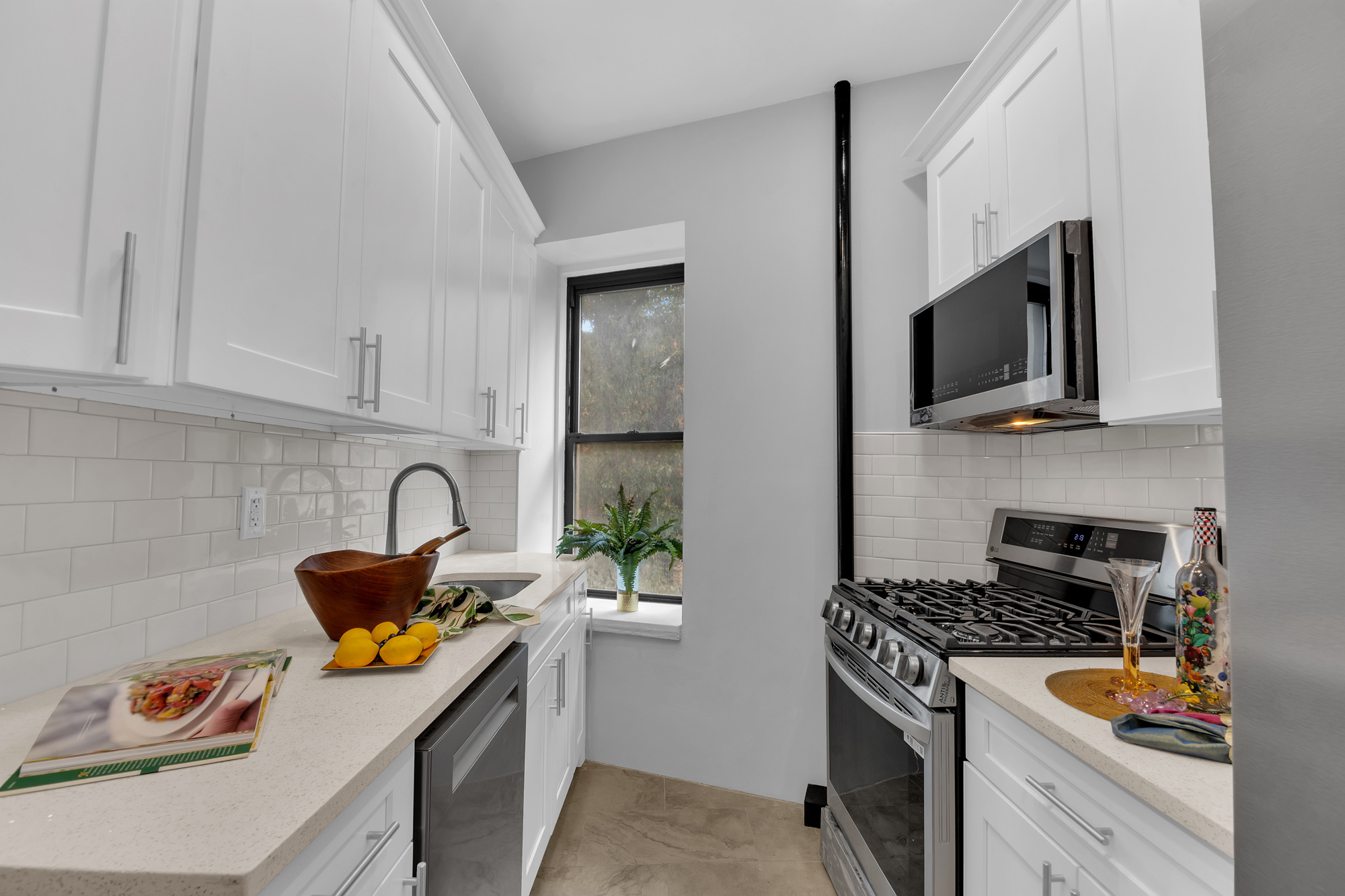 100 Hamilton Place, Unit 2F Manhattan, NY 10031 - Photo 7 of 21 a kitchen with stainless steel appliances granite countertop a sink stove top oven and cabinets