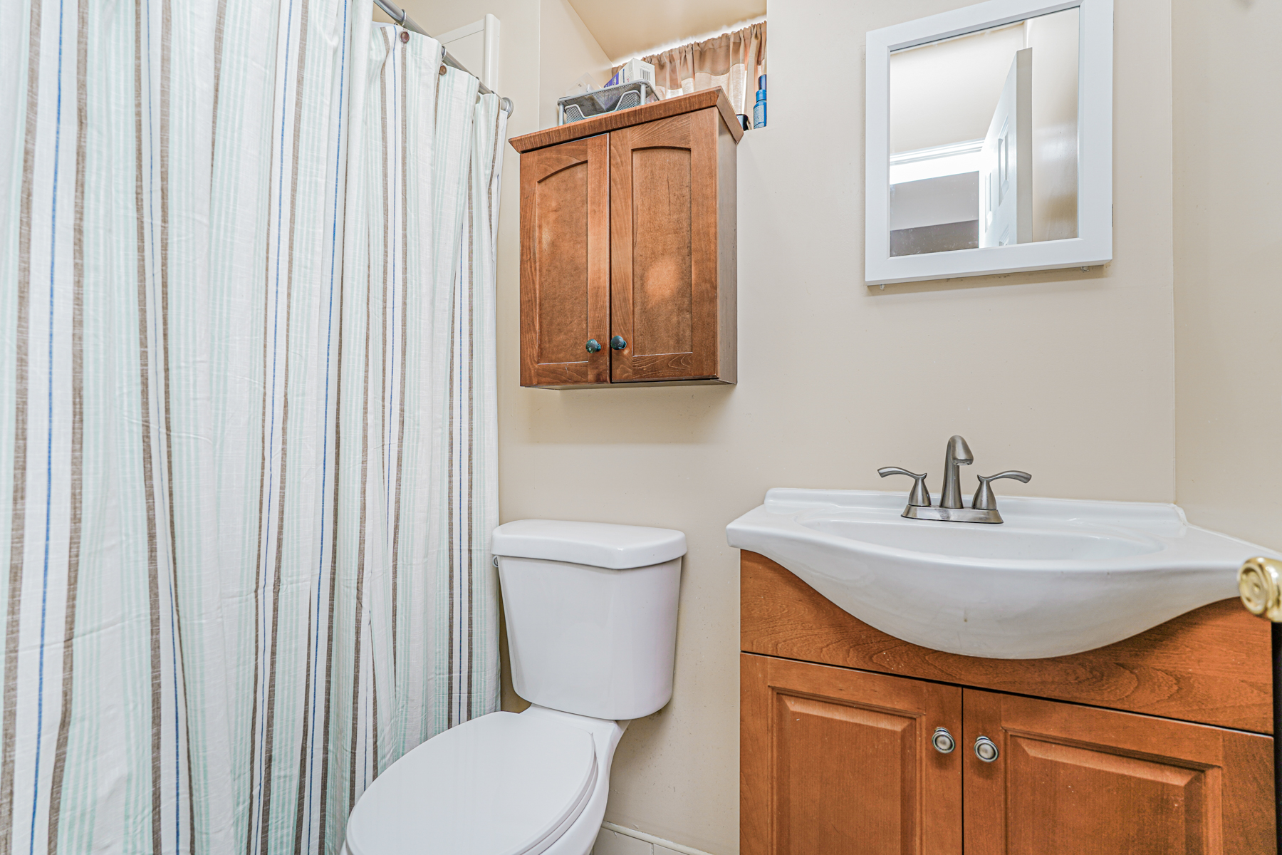 287 Greaves Avenue Staten Island, NY 10308 - Photo 26 of 35 a bathroom with a toilet a sink and a mirror