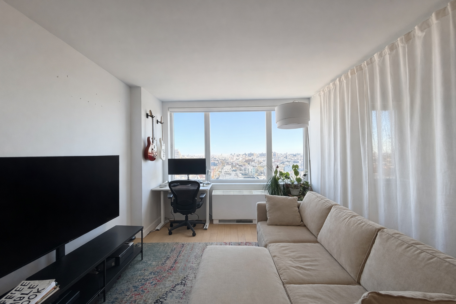 22 North 6th Street, Unit 19I Brooklyn, NY 11249 - Photo 2 of 8 a living room with furniture and a flat screen tv