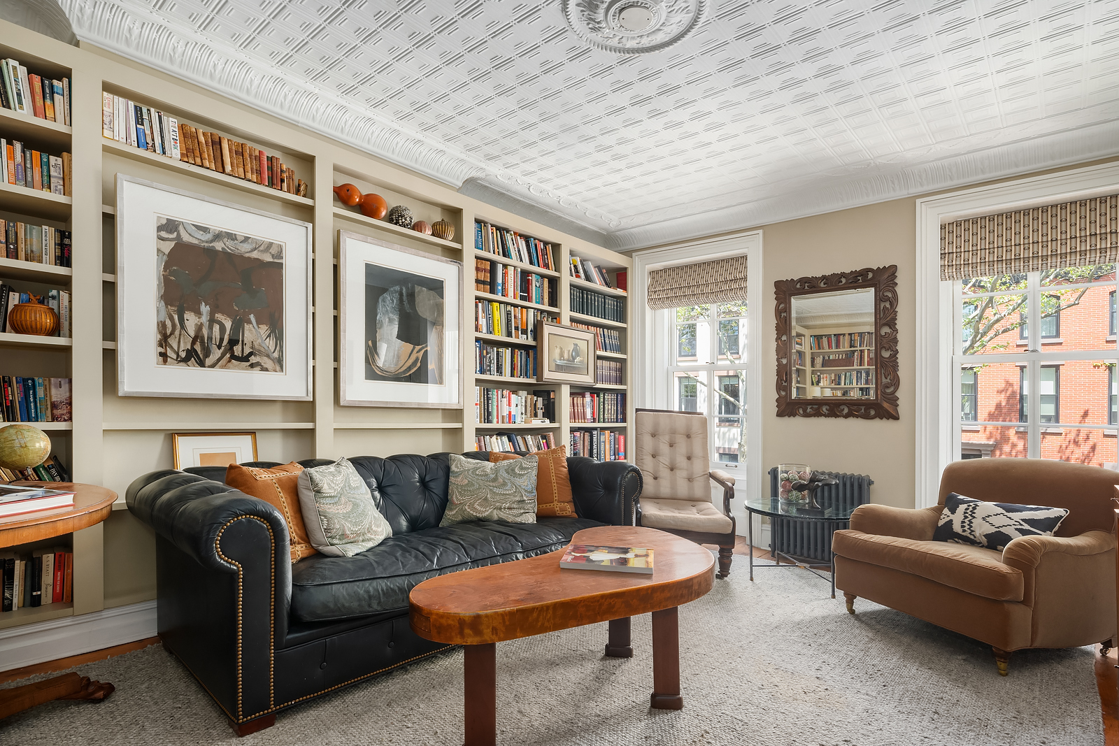 204 Warren Street Brooklyn, NY 11201 - Photo 11 of 29 a living room with furniture a bookshelf and a window