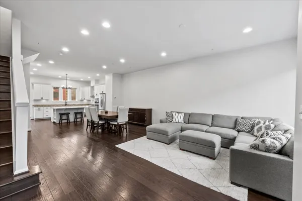 a living room with furniture and kitchen view
