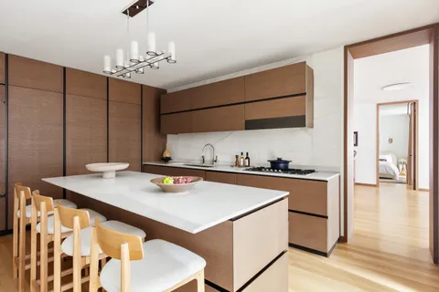 a kitchen that has a sink and a stove in it