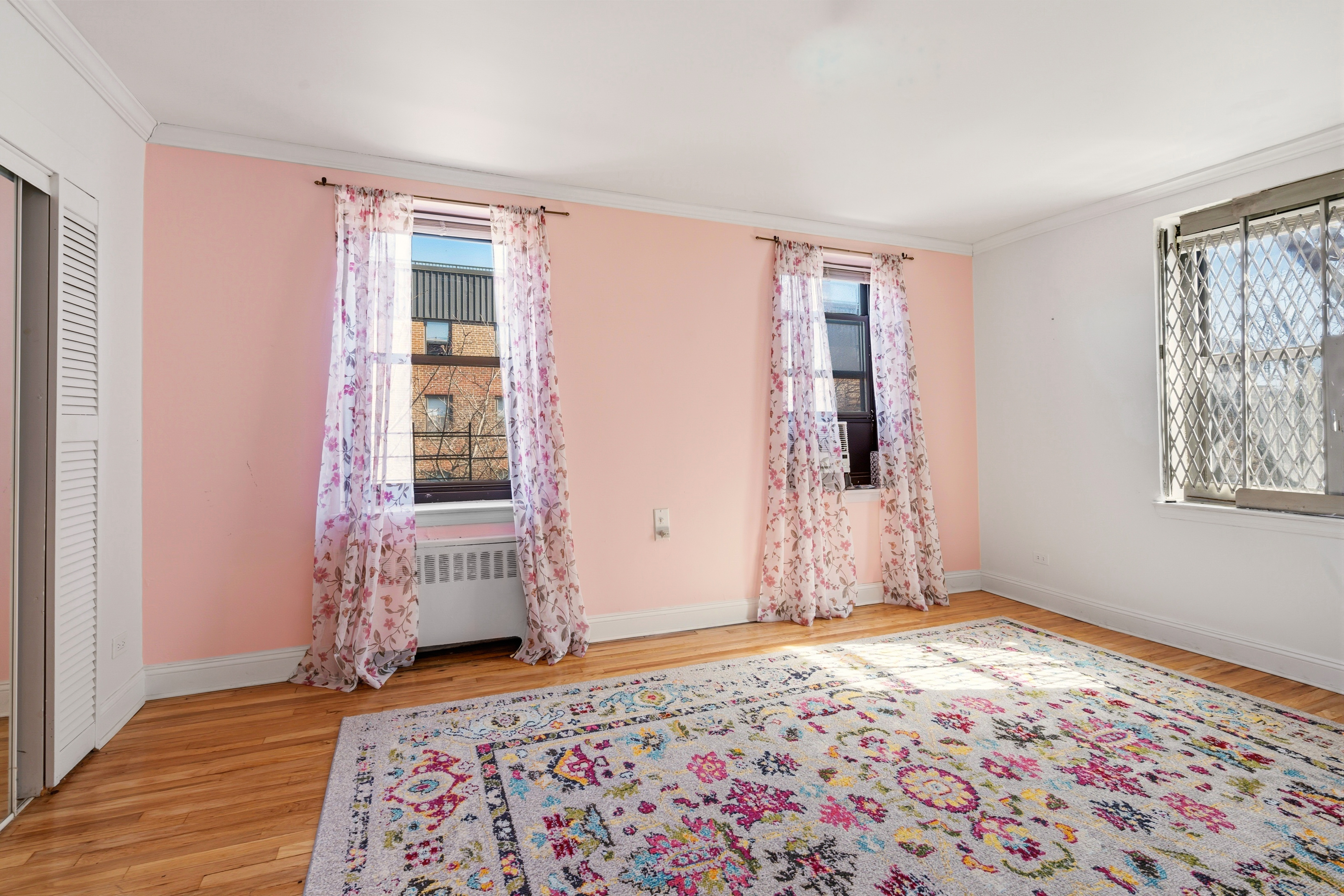32-40 91st Street, Unit 510 Queens, NY 11369 - Photo 3 of 5 a view of a livingroom with wooden floor and a window