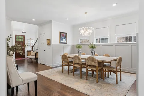 a view of a dining room with furniture and chandelier