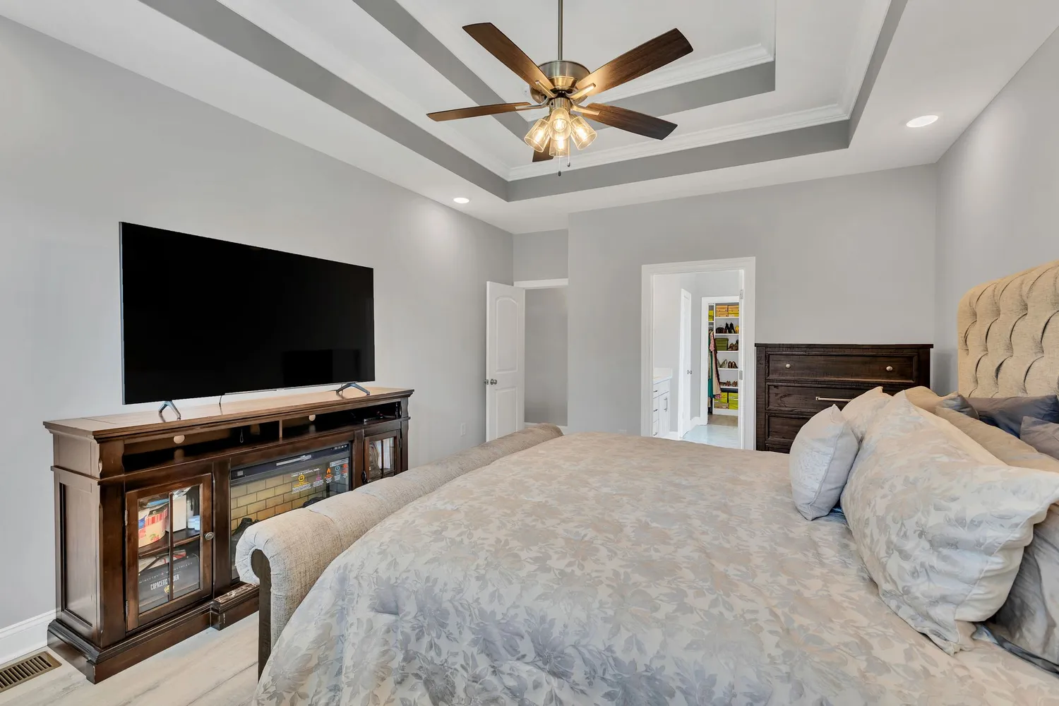 a bedroom with a bed and a flat screen tv