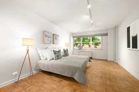 a bedroom with a large bed and a window