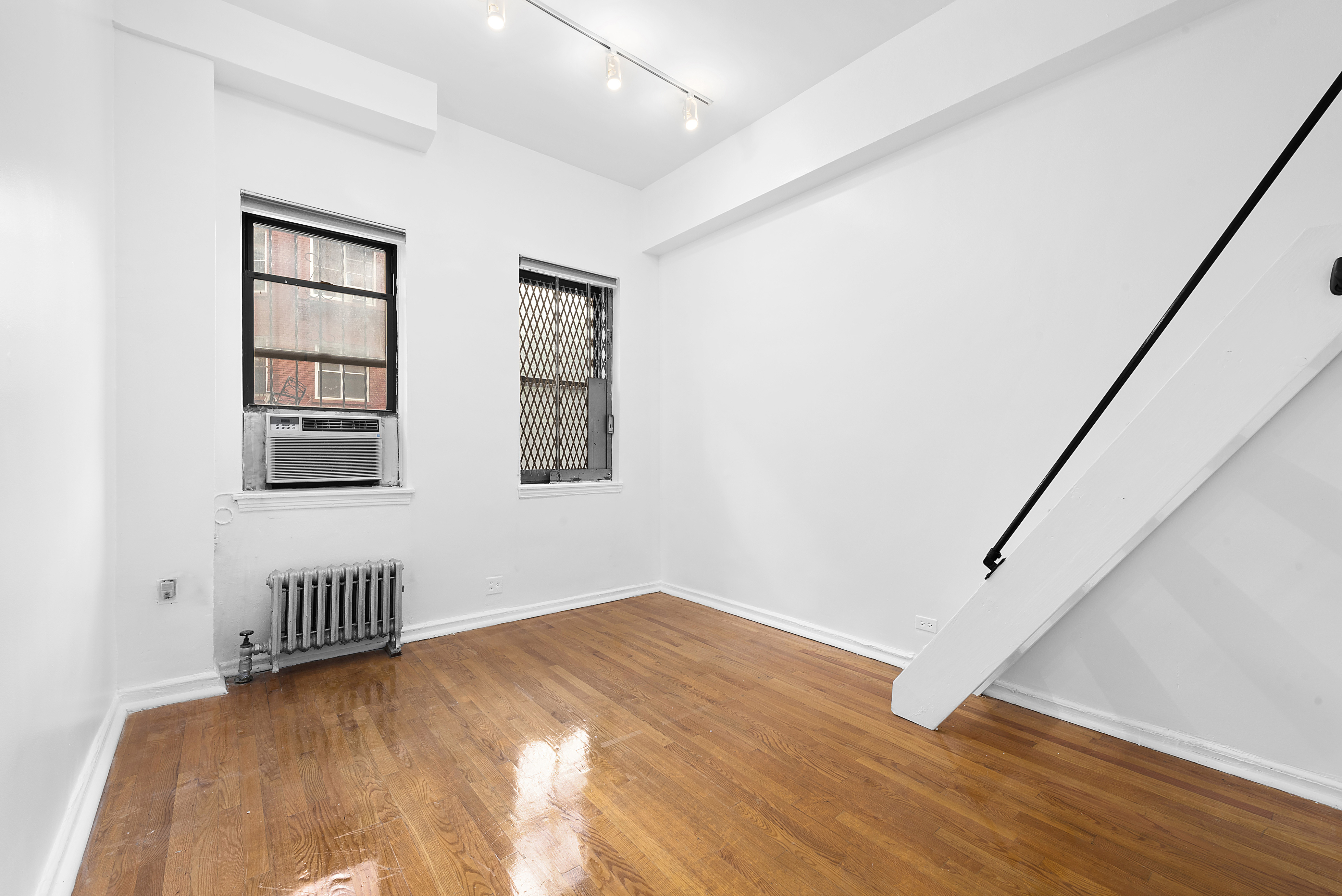159-34 Riverside Drive West, Unit 1F90 Manhattan, NY 10032 - Photo 3 of 14 a view of an empty room with a window