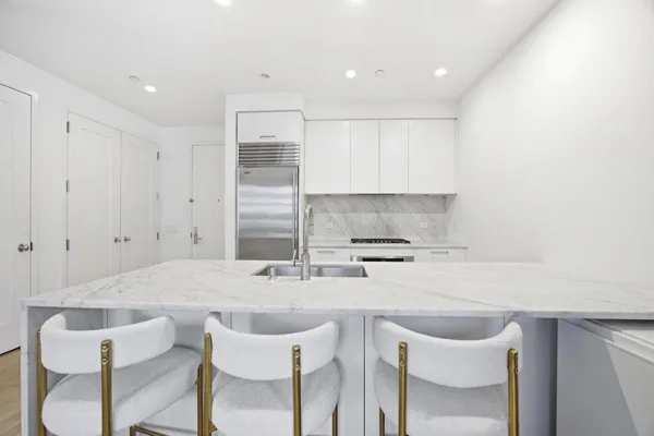 a kitchen with a sink cabinets and window