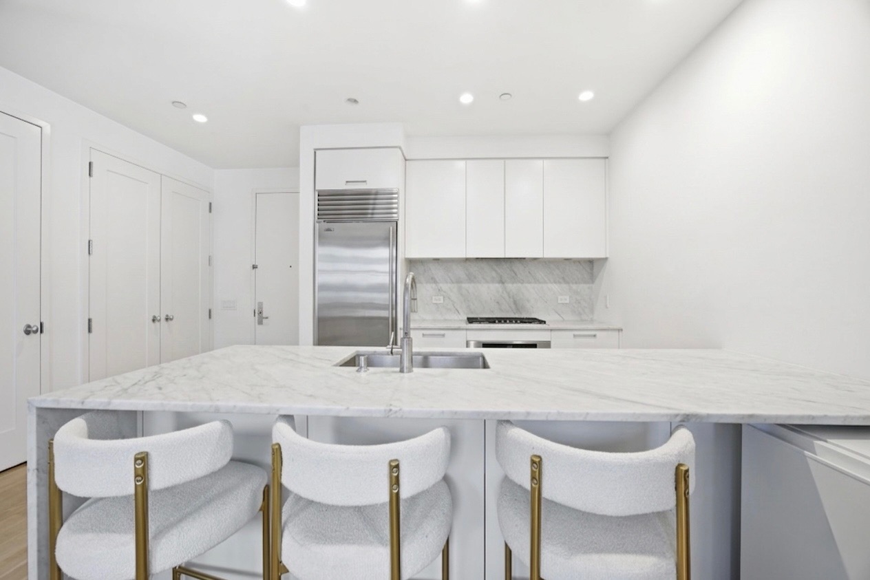 71 Nassau Street, Unit 13C Manhattan, NY 10038 - Photo 5 of 16 a kitchen with a sink cabinets and window