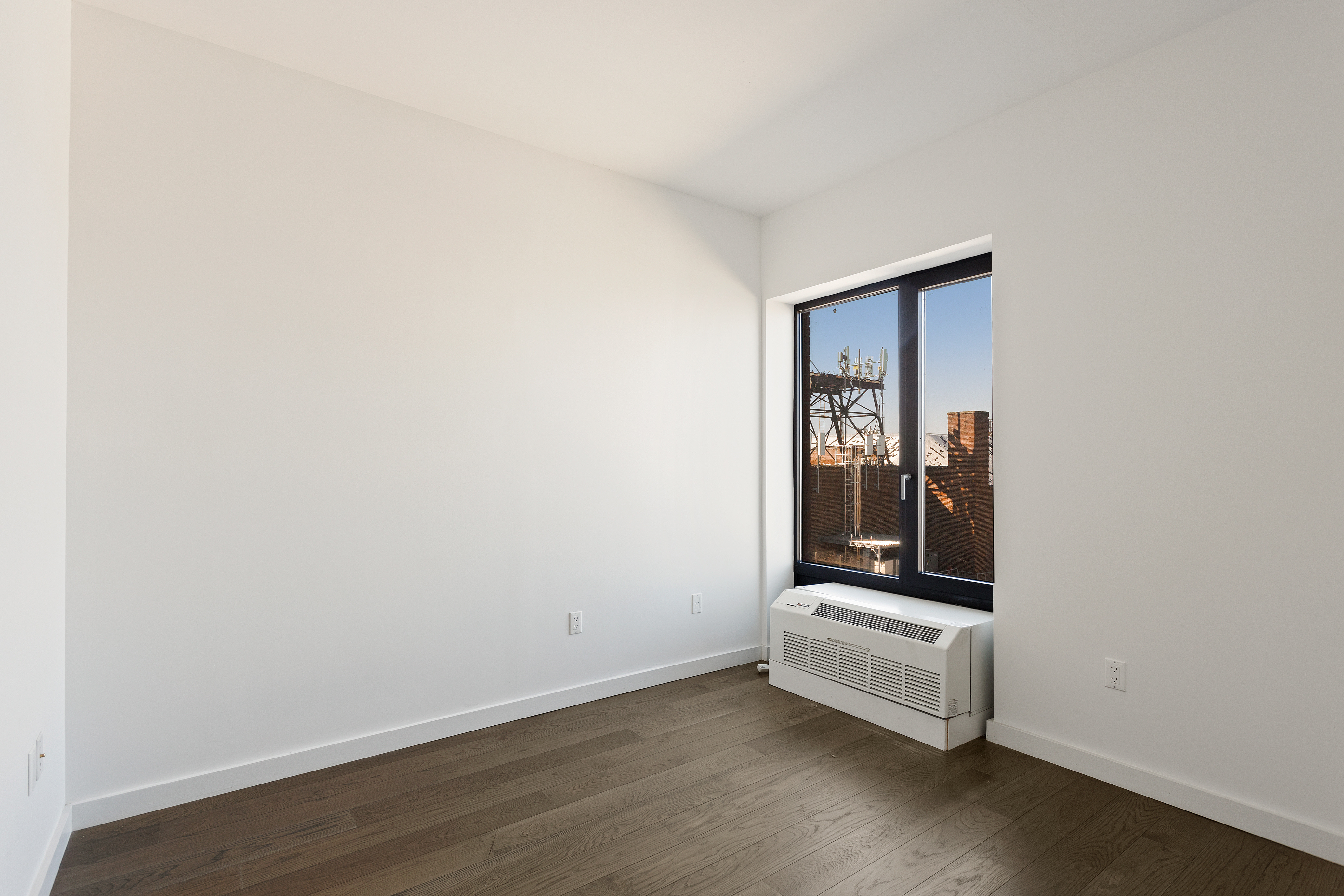 16-26 Madison Street, Unit PHA Queens, NY 11385 - Photo 4 of 16 a view of a room with wooden floor and mirror