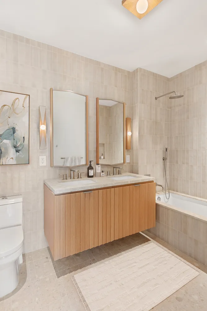 a bathroom with a tub sink and mirror