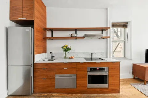 a kitchen with stainless steel appliances granite countertop a stove a refrigerator and a sink