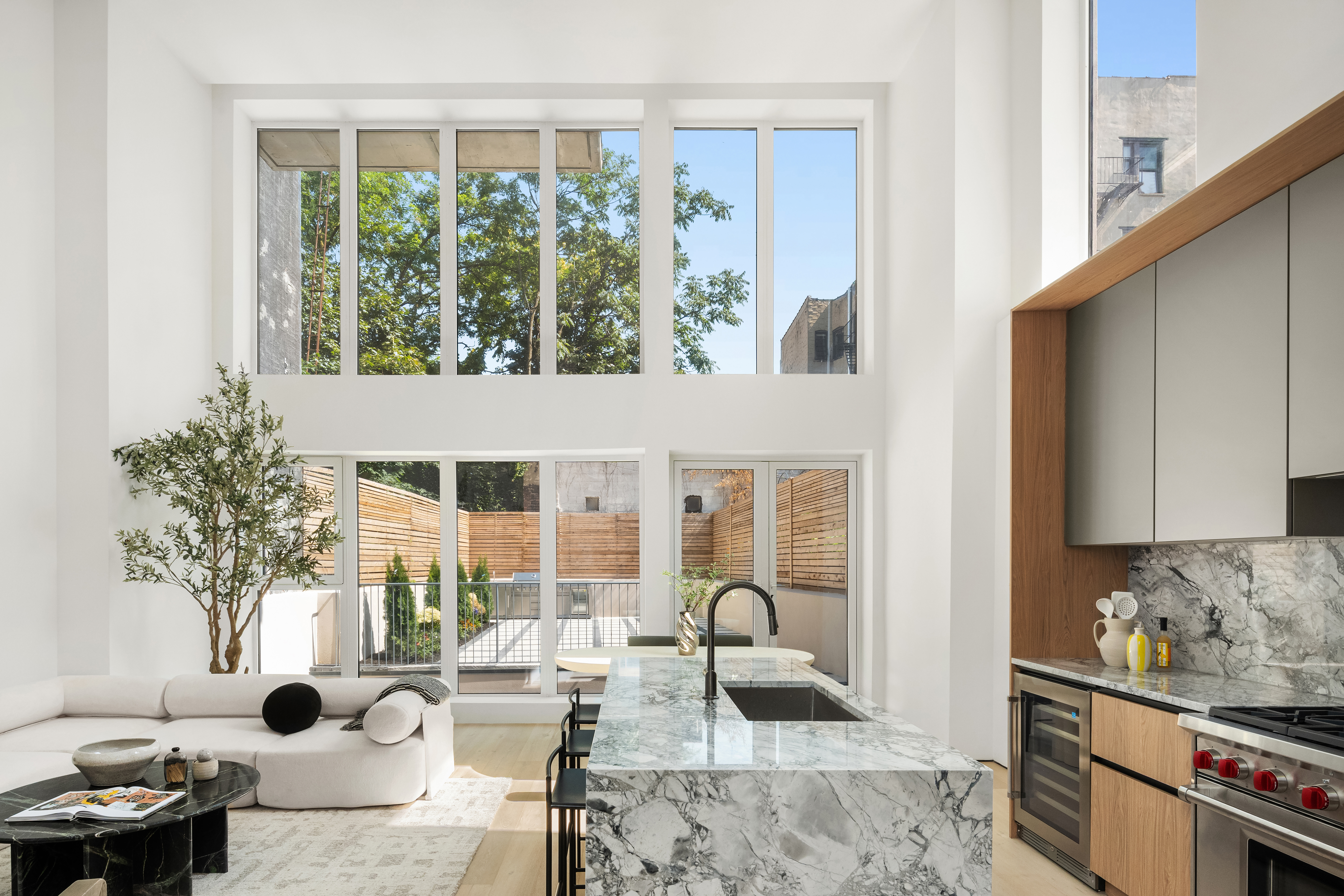 79 South 2nd Street Brooklyn, NY 11249 - Photo 2 of 14 a living room with furniture and a large window