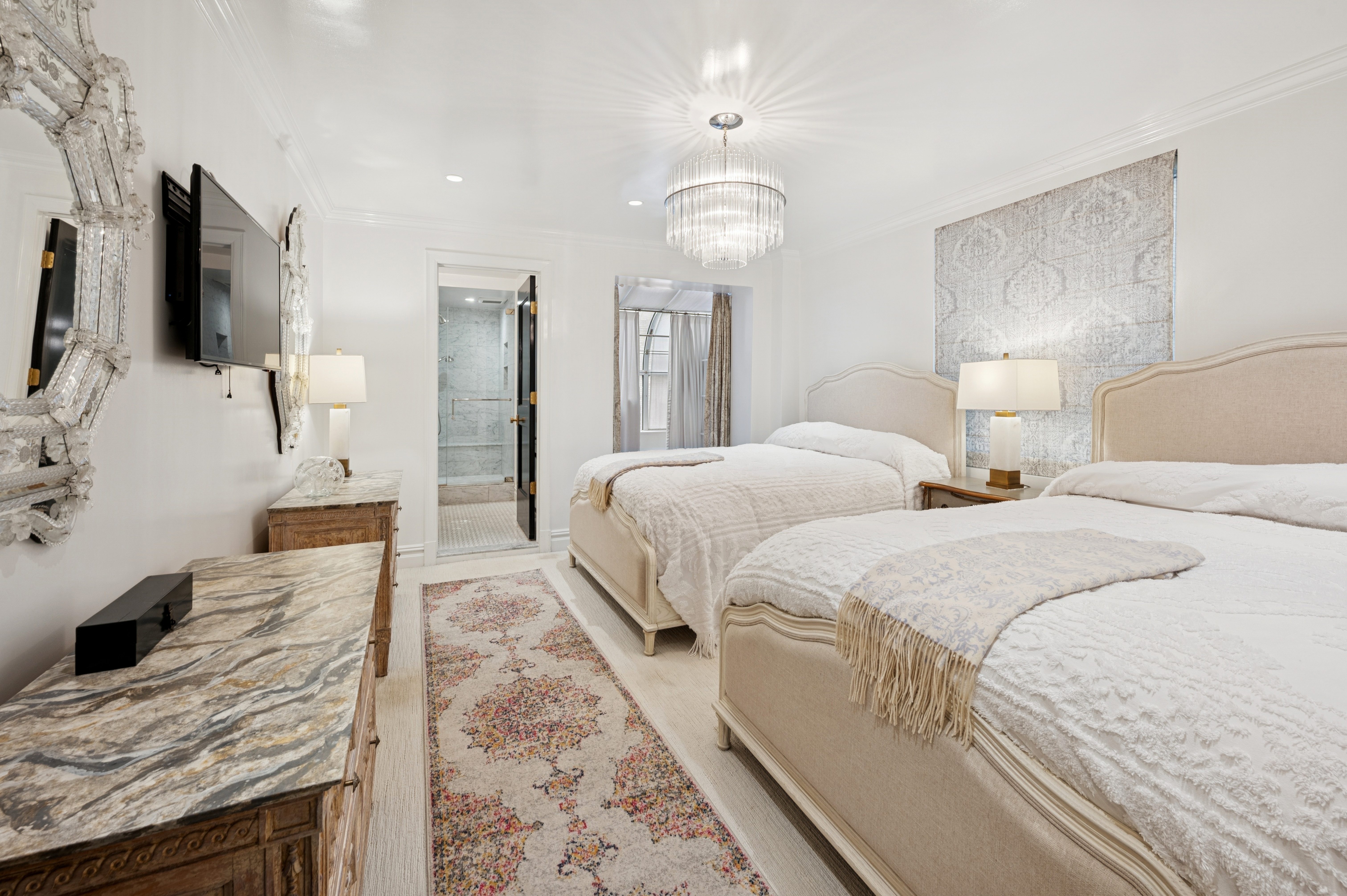 891 Park Avenue, Unit 10 Manhattan, NY 10075 - Photo 15 of 27 a spacious bedroom with two bed and a flat screen tv